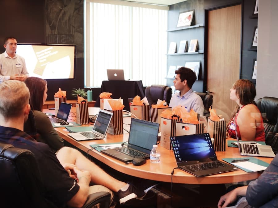 A speaker presenting to a boardroom of colleagues.